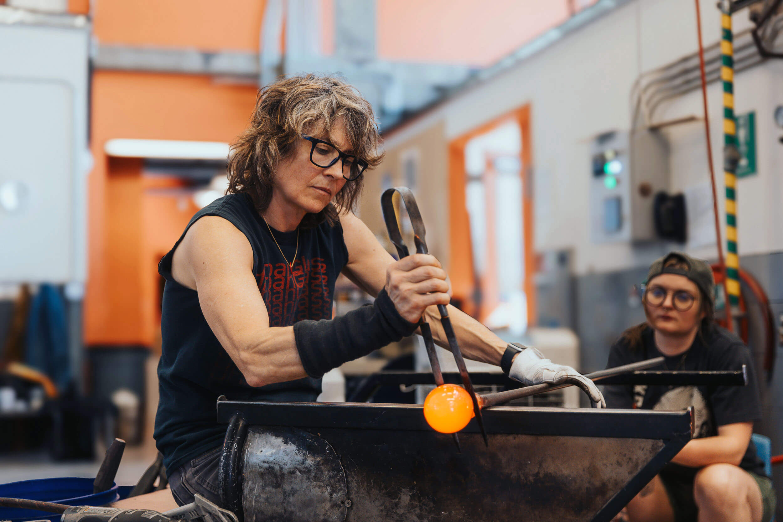 artist working glass at the bench
