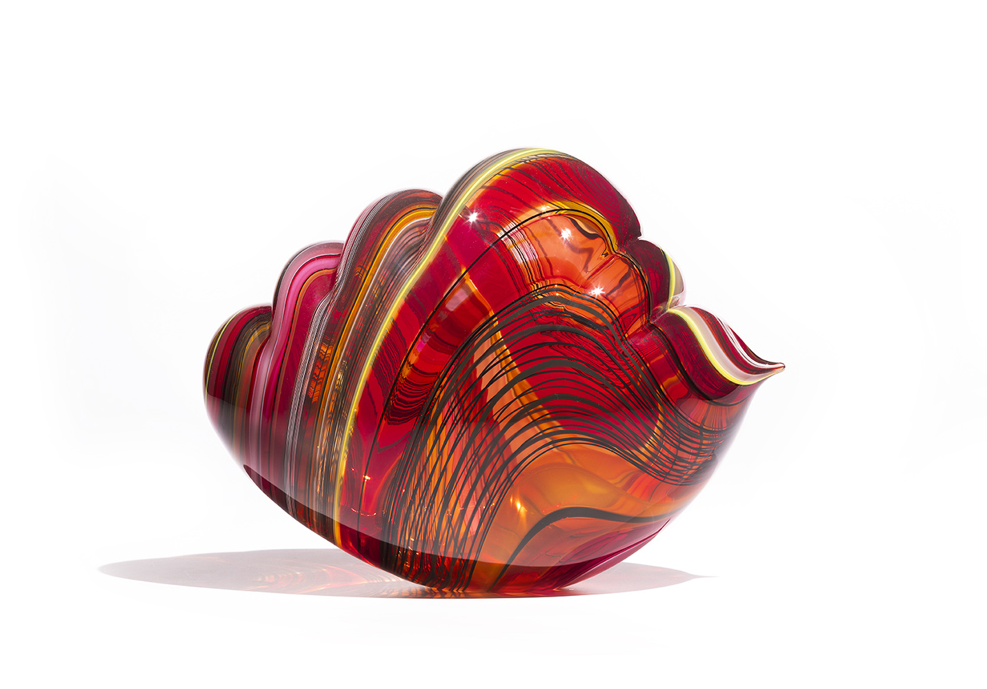 glass sculpture in the shape of a cloud with red, orange and black wavy stripes