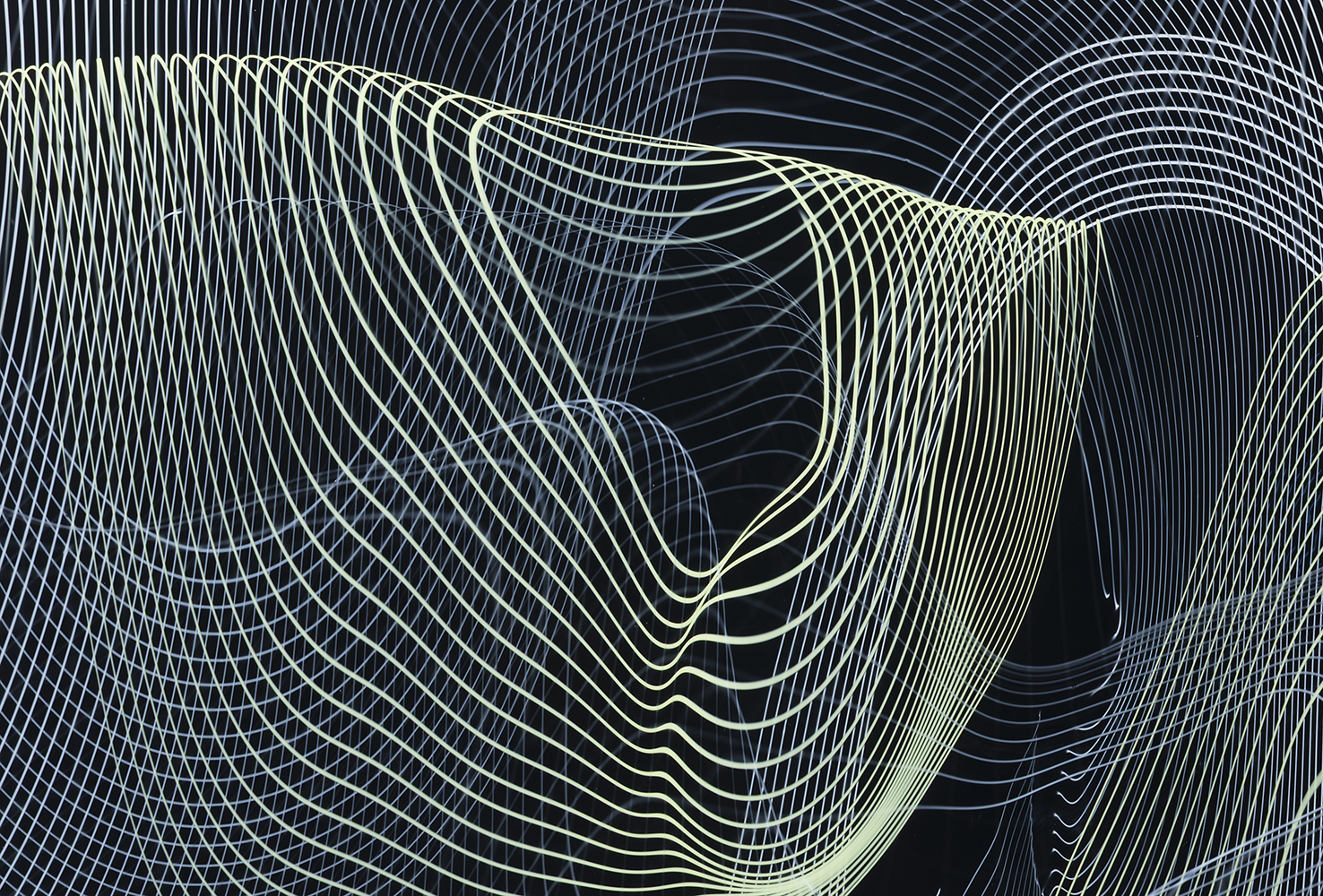 detail of spiral pattern in light green and white over black glass