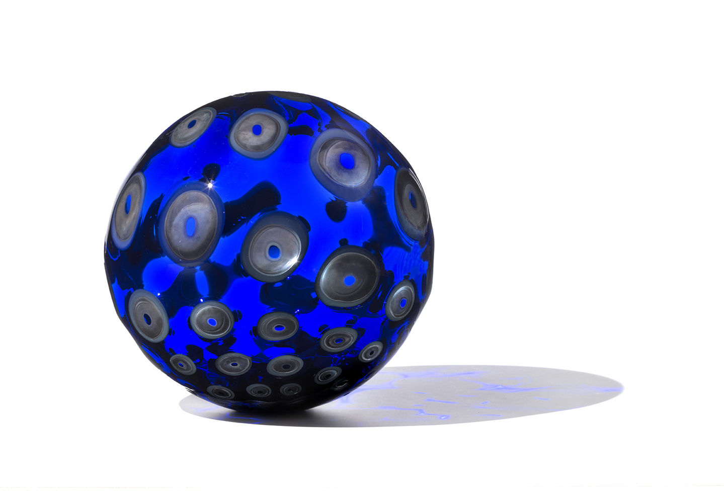 vivid deep blue glass orb with silver dots