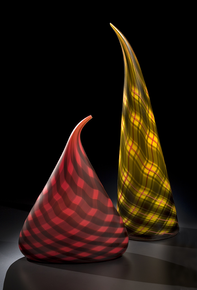 glass sculptures with red, black and yellow plaid patterns