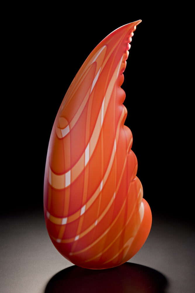 red-orange sculpture in the shape of a lobster claw with plaid pattern
