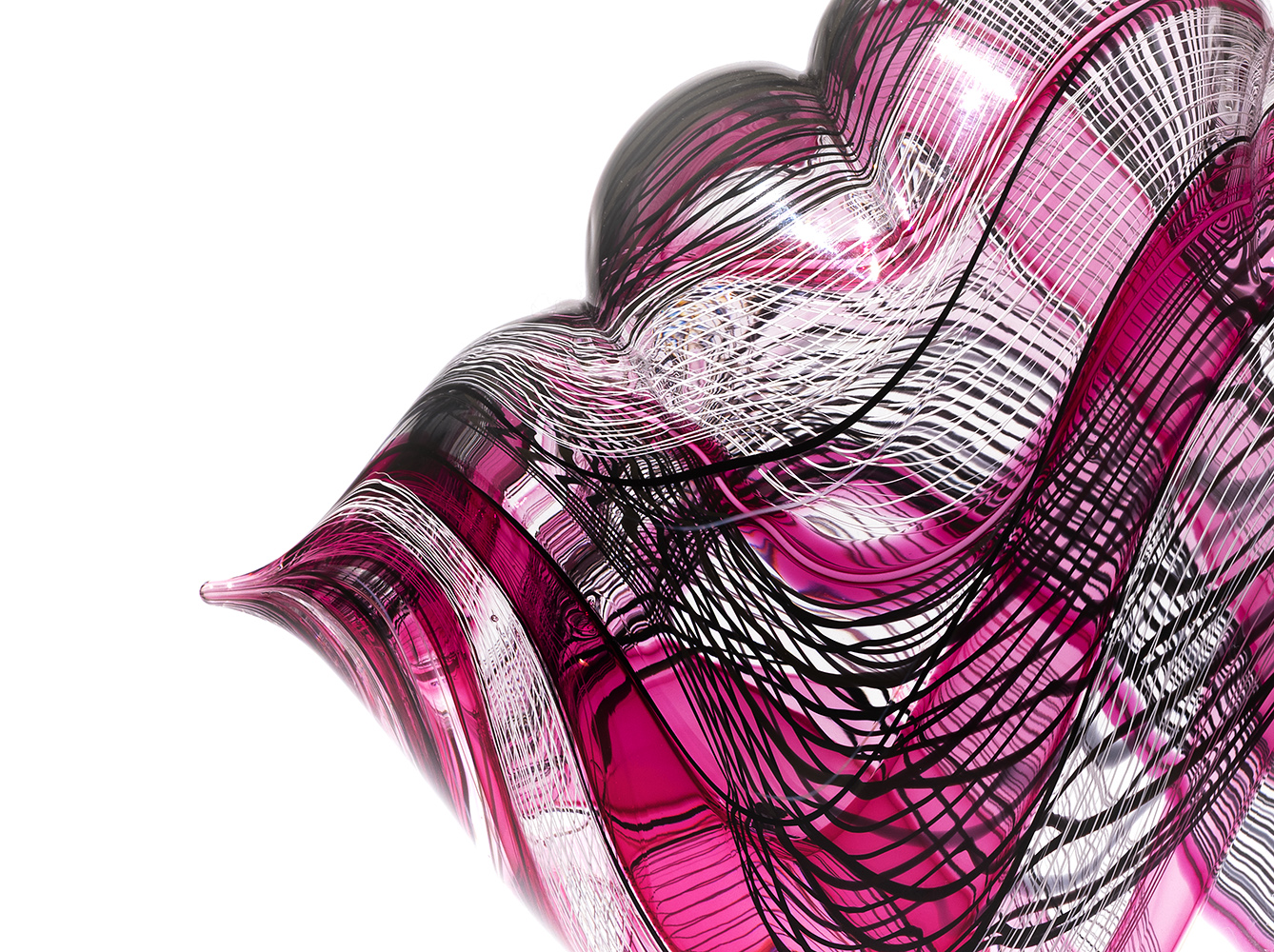 detail of glass sculpture showing pink, black and white lines in swirling patterns