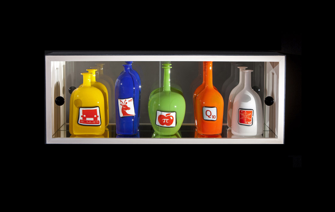 small cabinet with five colorful glass bottles