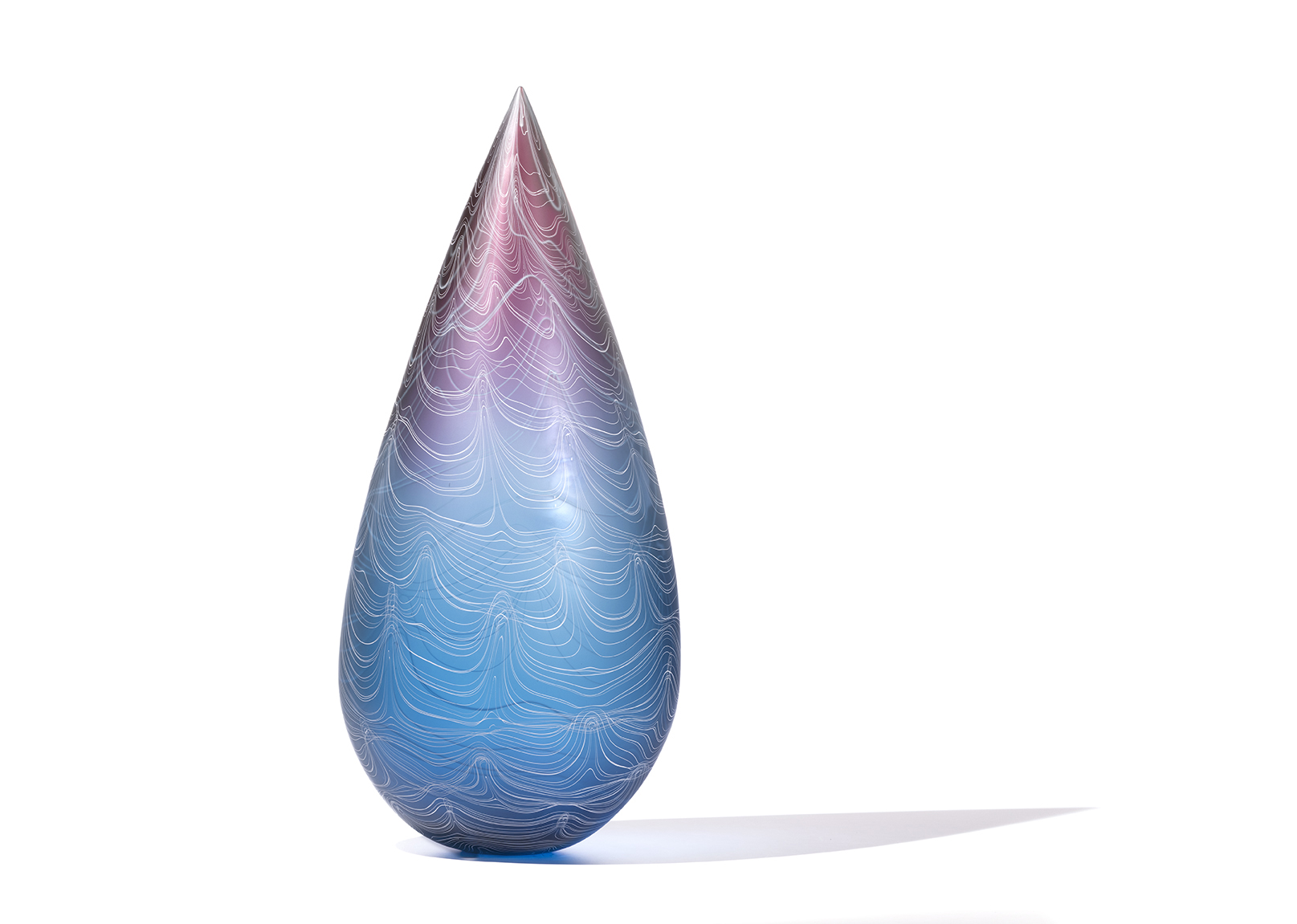 tall teardrop shaped glass sculpture with fade from purple at top to blue at bottom