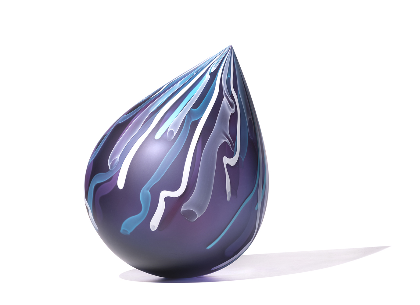 Deep purple glass sculpture in droplet shape with wavy blue and white lines 