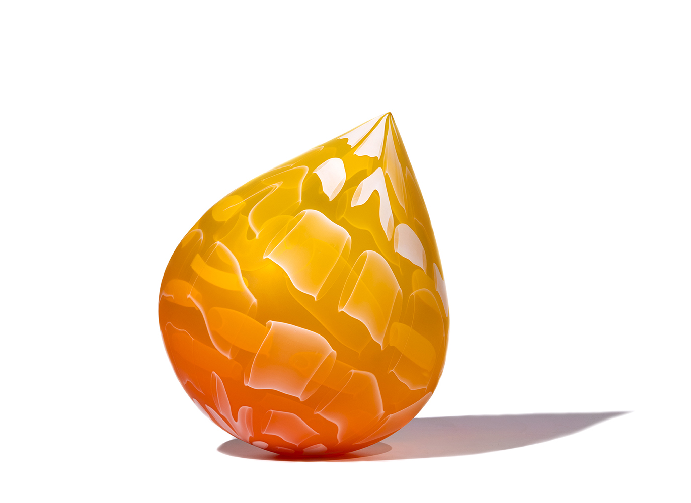 glass sculpture in droplet shape with dark orange to yellow at tip fade